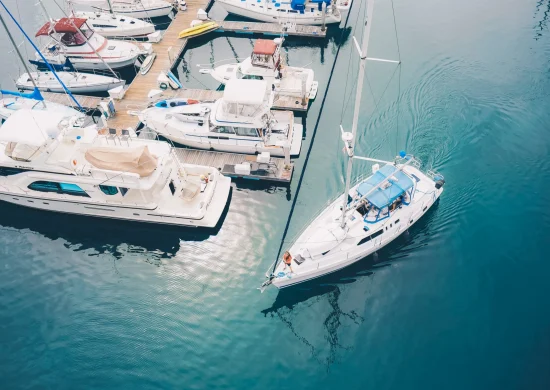 white-boat-leaving-marina-docks-sailing-water-scaled